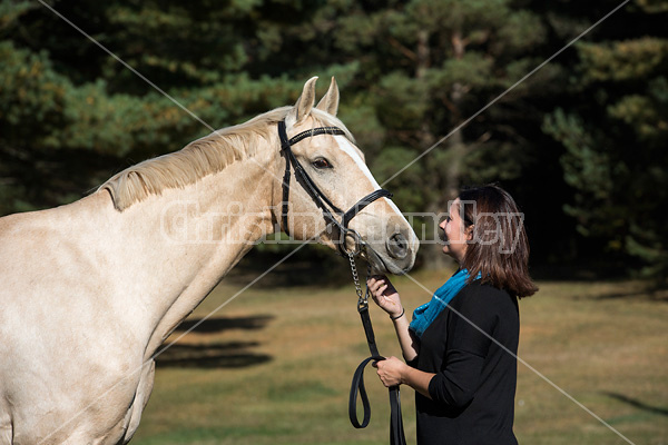 Woman with a palomino horse