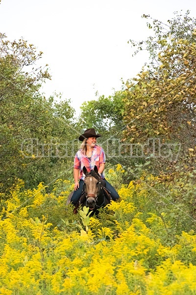 Young woman horseback riding western 