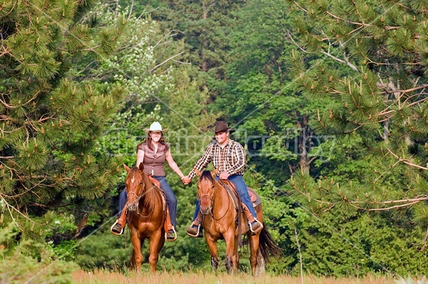 Young couple horseback riding