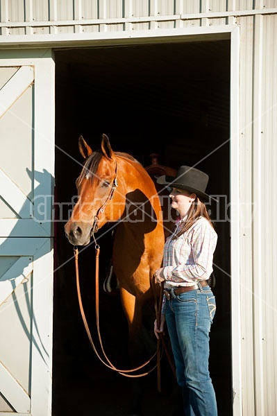 Portrait of a young woman and her American Quarter Horse gelding