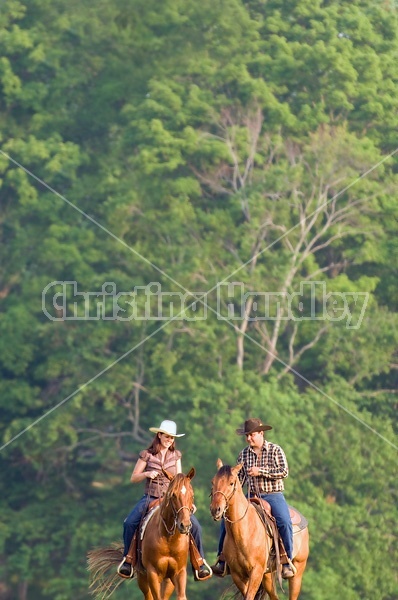 Young couple horseback riding