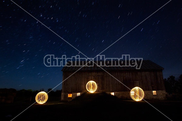 Light painting at night in front of big barn