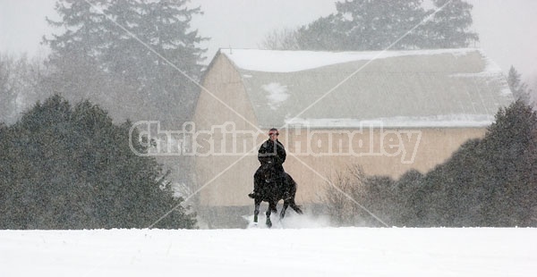 Woman horseback riding in the winter