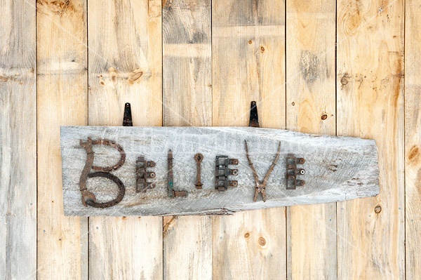 Hand crafted Believe art sign made out of wood and recycled or repurposed farm tools and machinery parts