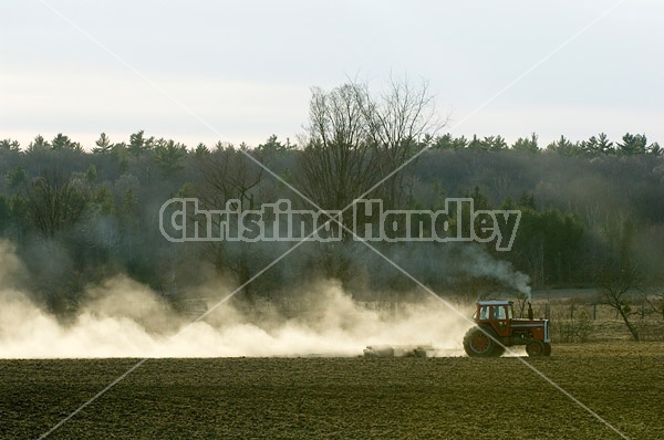 Farmer working a field in the springtime