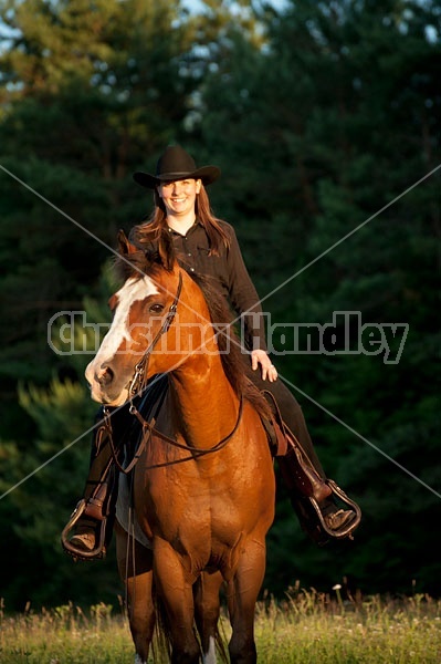 Young woman riding her American Paint horse mare