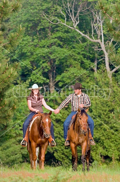 Young couple horseback riding