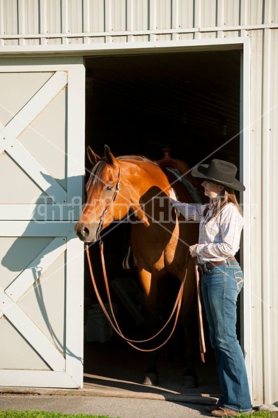 Portrait of a young woman and her American Quarter Horse gelding