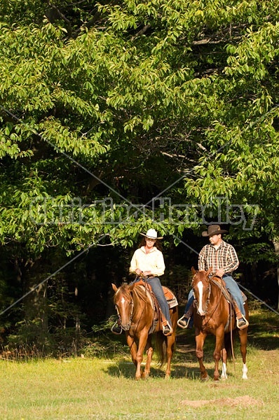 Husband and Wife Trail Riding Together