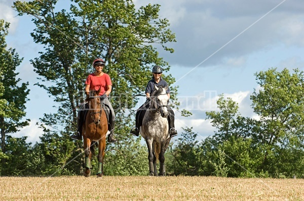 Two women horseback riding