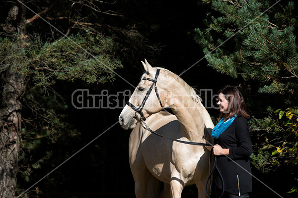 Woman with a palomino horse