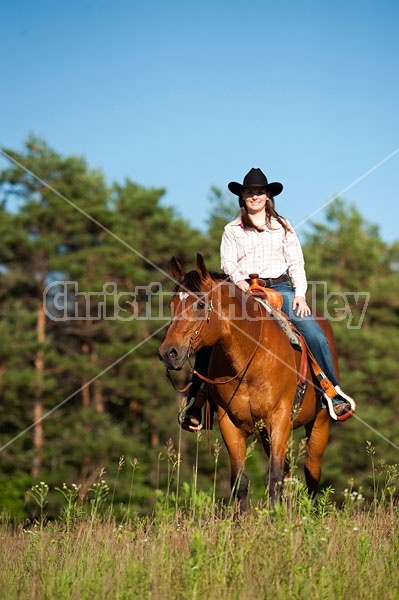 Young woman riding an American Quarter Horse gelding 