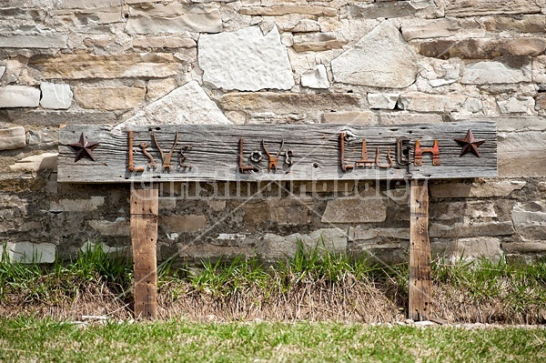 Hand crafted garden art sign made out of wood and recycled or repurposed farm tools and machinery parts