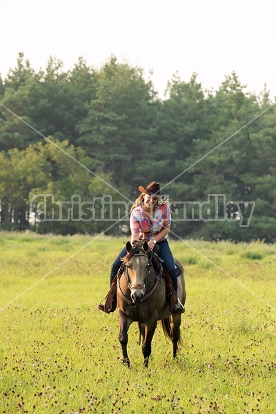 Young woman horseback riding western 