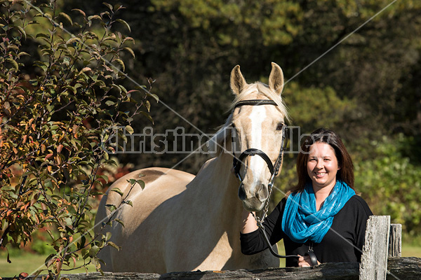 Woman with a palomino horse