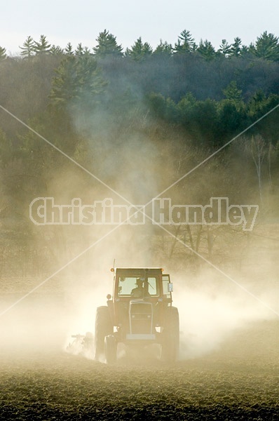 Farmer working a field in the springtime
