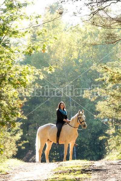 Woman riding a palomino horse