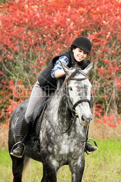 Portrait of young woman on horse