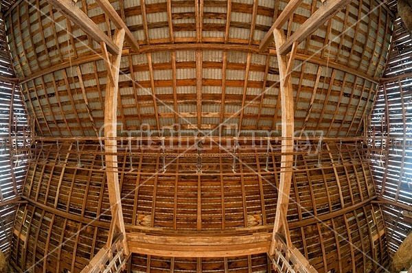Looking straight up at the ceiling and rafters of the hayloft in an old style barn