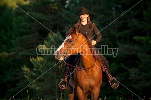 Young woman riding her American Paint horse mare