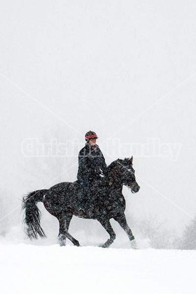 Woman horseback riding in the winter