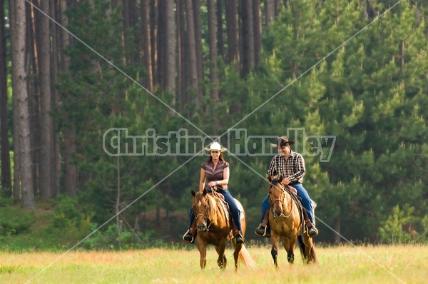 Young couple horseback riding