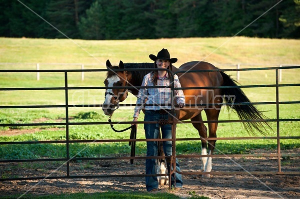 Young woman catching her Paint mare out of the paddock