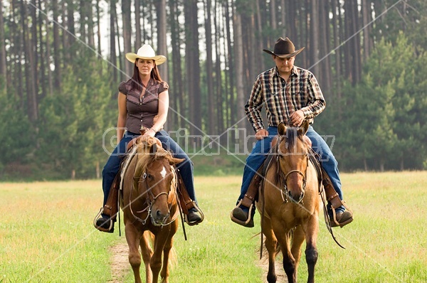 Young couple horseback riding