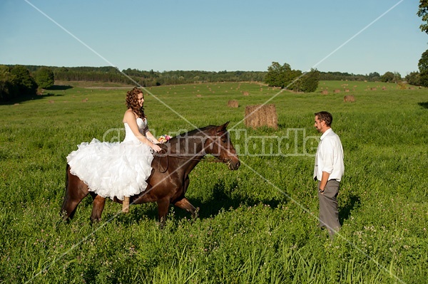 Bride and groom with horse