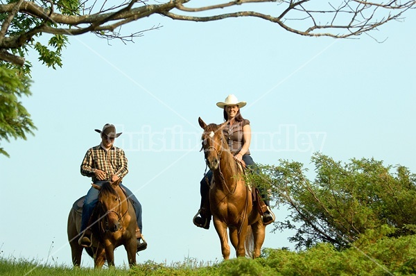 Young couple horseback riding