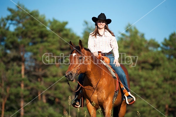 Young woman riding an American Quarter Horse gelding 