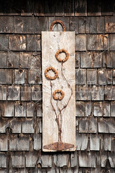 Hand crafted garden art sign made out of wood and recycled or repurposed farm tools and machinery parts