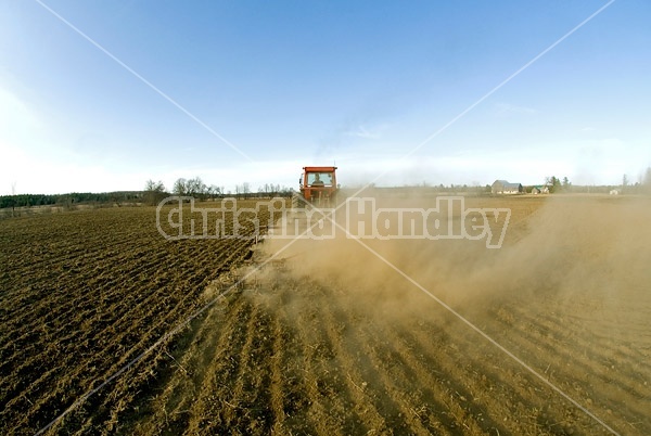 Farmer working a field in the springtime