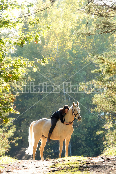 Woman riding a palomino horse