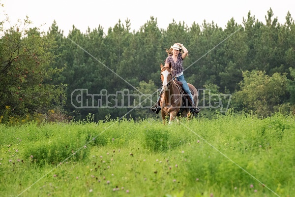 Young woman horseback riding western 