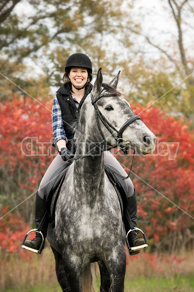 Portrait of young woman on horse