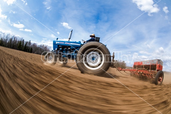 Farmer seeding oats in the springtime