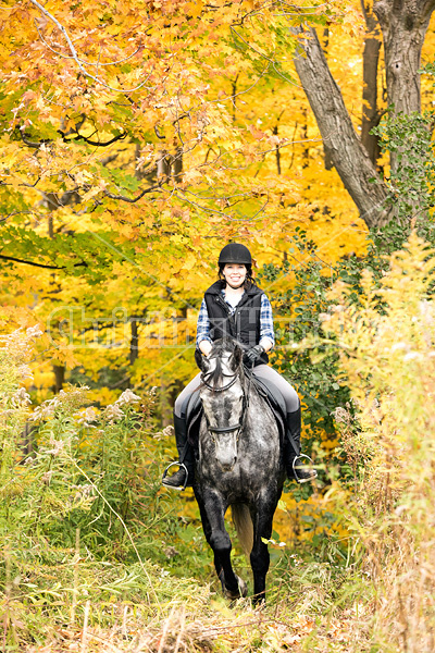 Portrait of young woman on horse