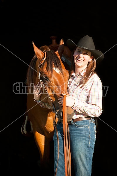 Portrait of a young woman and her American Quarter Horse gelding