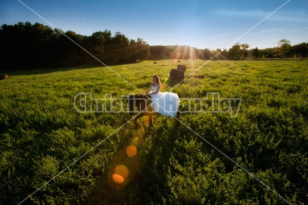 Woman riding horse wearing a wedding dress