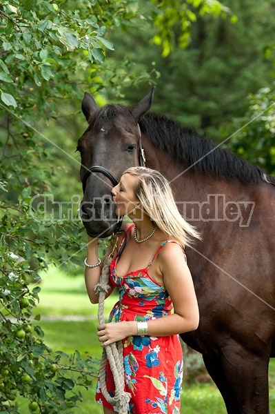 Young woman with her dark bay horse