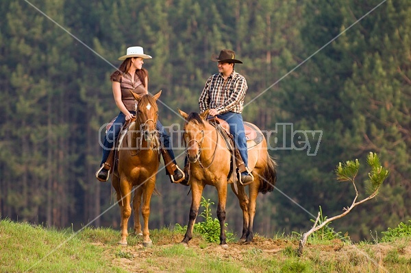 Young couple horseback riding