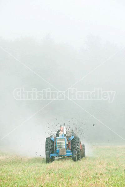 Spreading manure in the early morning fog