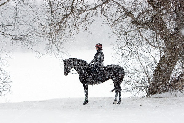 Woman horseback riding in the winter