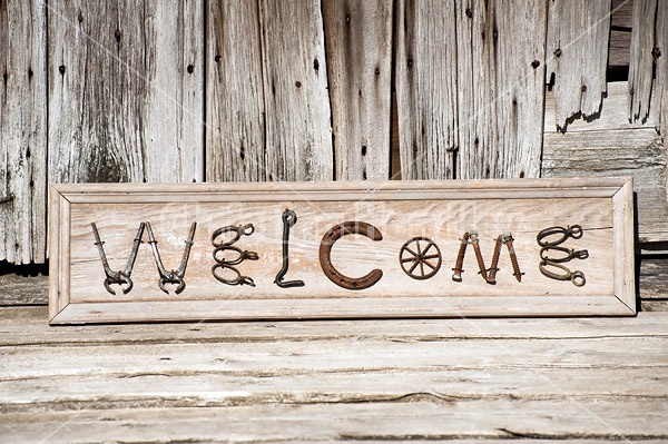 Hand crafted Welcome art sign made out of wood and recycled or repurposed farm tools and machinery parts