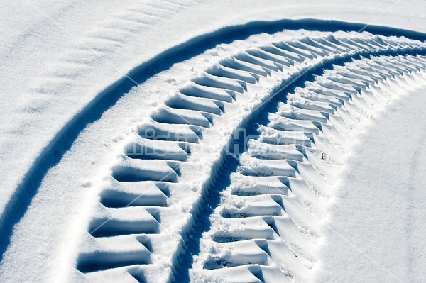 Photo of tractor tire tracks in the snow
