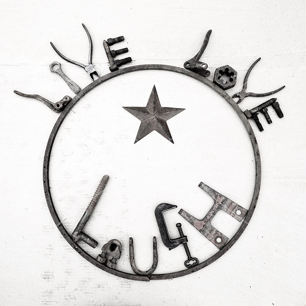 Hand crafted Live Love Laugh art sign made out of recycled or repurposed farm tools and machinery parts then welded together