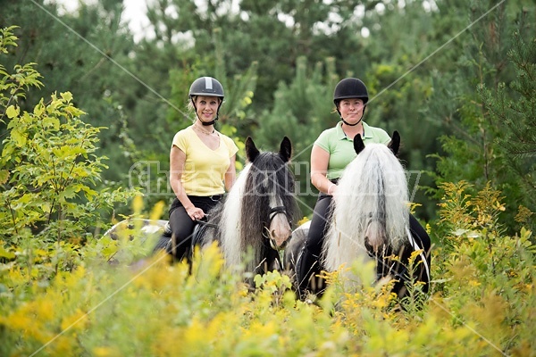 Two women riding Gypsy Vanner horses