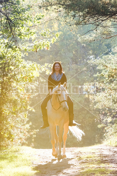 Woman riding a palomino horse