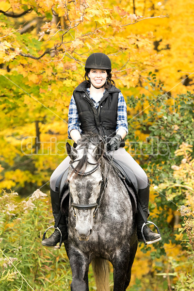 Portrait of young woman on horse